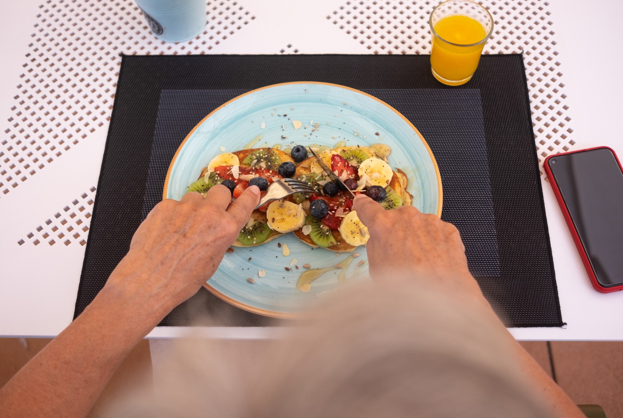 Hands plating a local dish in workshop